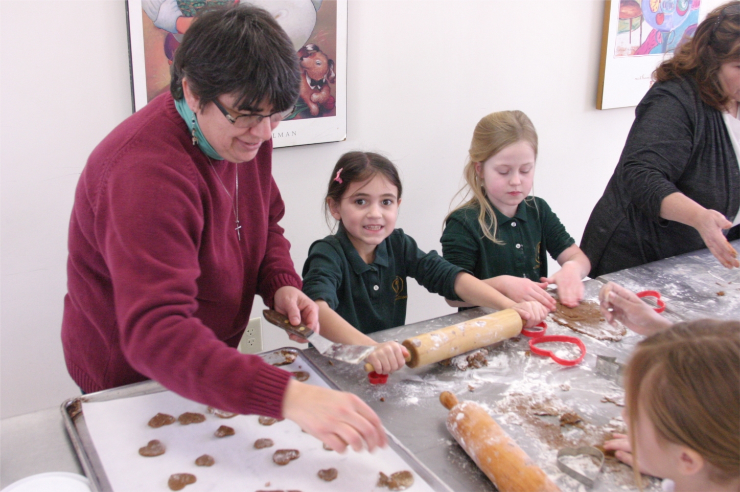 Sister Betsy VanDeusen, Director of Community Partnerships, works with students from St. Thomas, making cookies for seniors served by Catholic Charities.