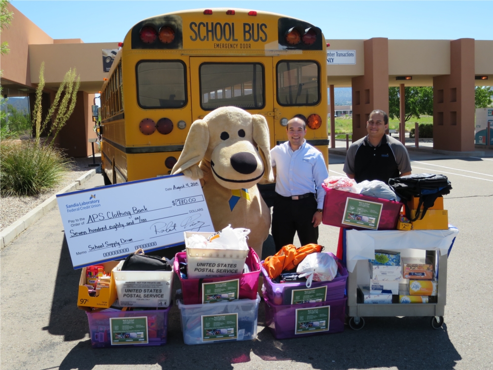 SLFCU employees and Sandy the Lab help with the Albuquerque Public Schools Supplies Drive