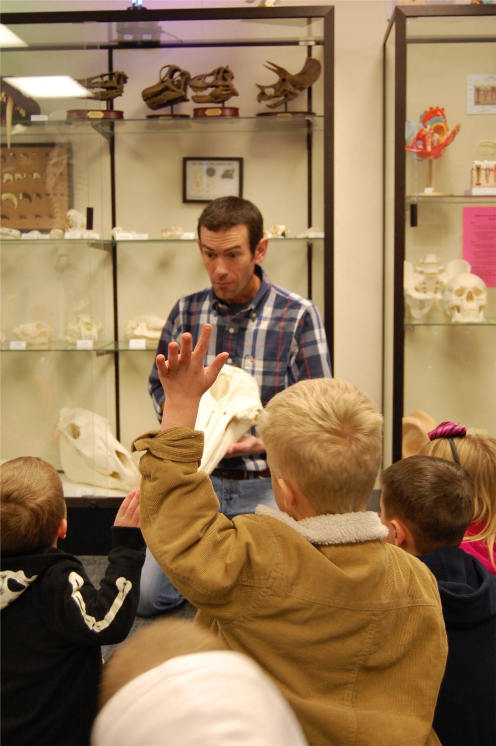 Todd Kuykendall, biology instructor and supervisor of the CCC Children's Science Musuem, shows various animal skulls to a class of visiting preschool students.