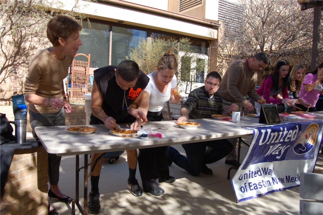 CCC President Dr. Becky Rowley (left) competes with employees during a pumpkin pie eating contest. All proceeds of the event went to benefit the United Way of Eastern New Mexico.