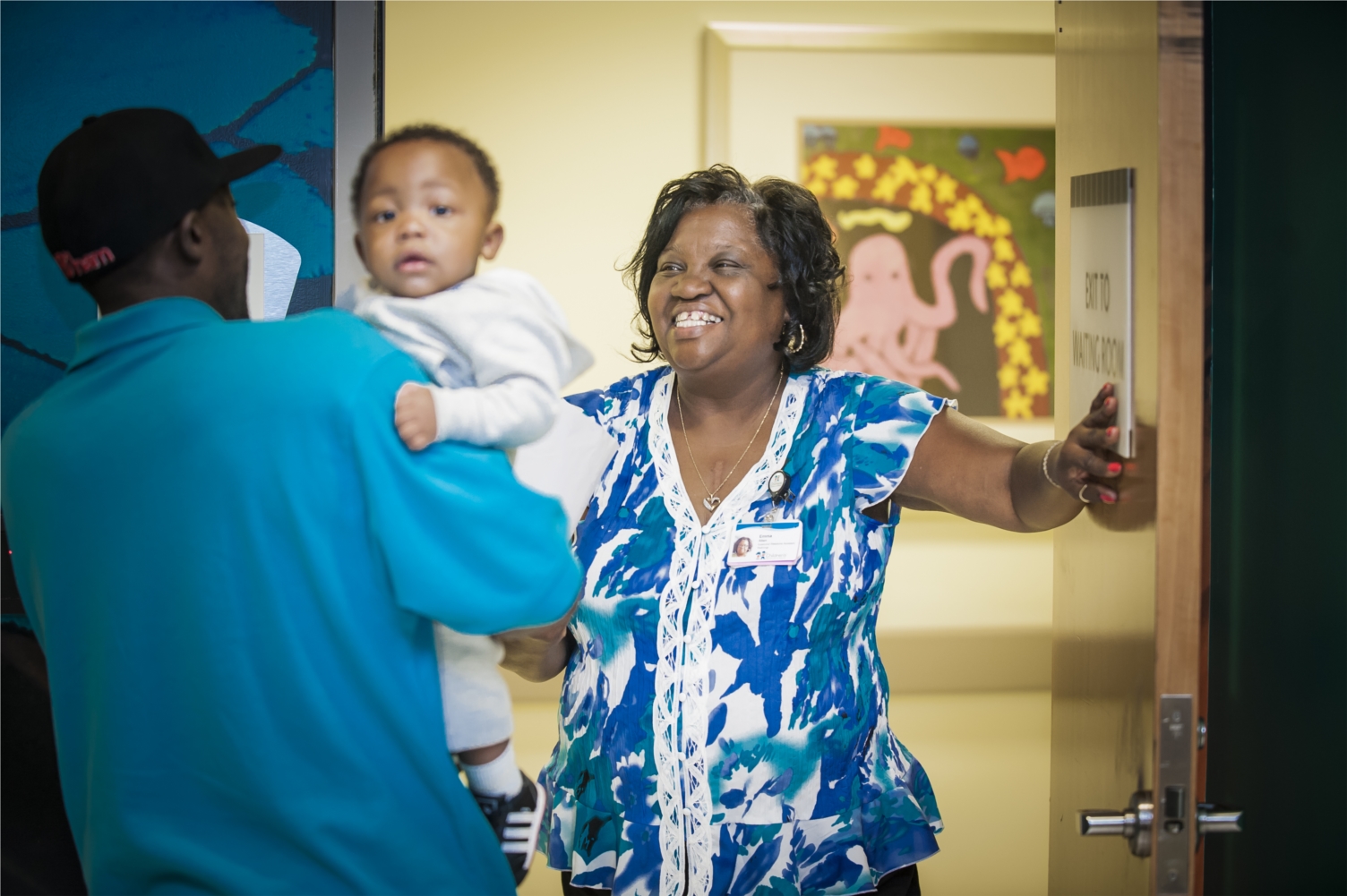 A Children's employee welcomes a patient.