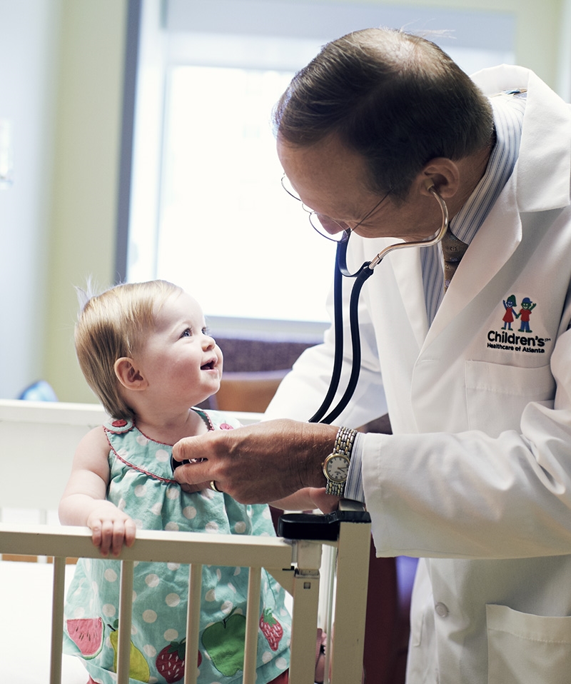 A Children's physician checks on a young patient.