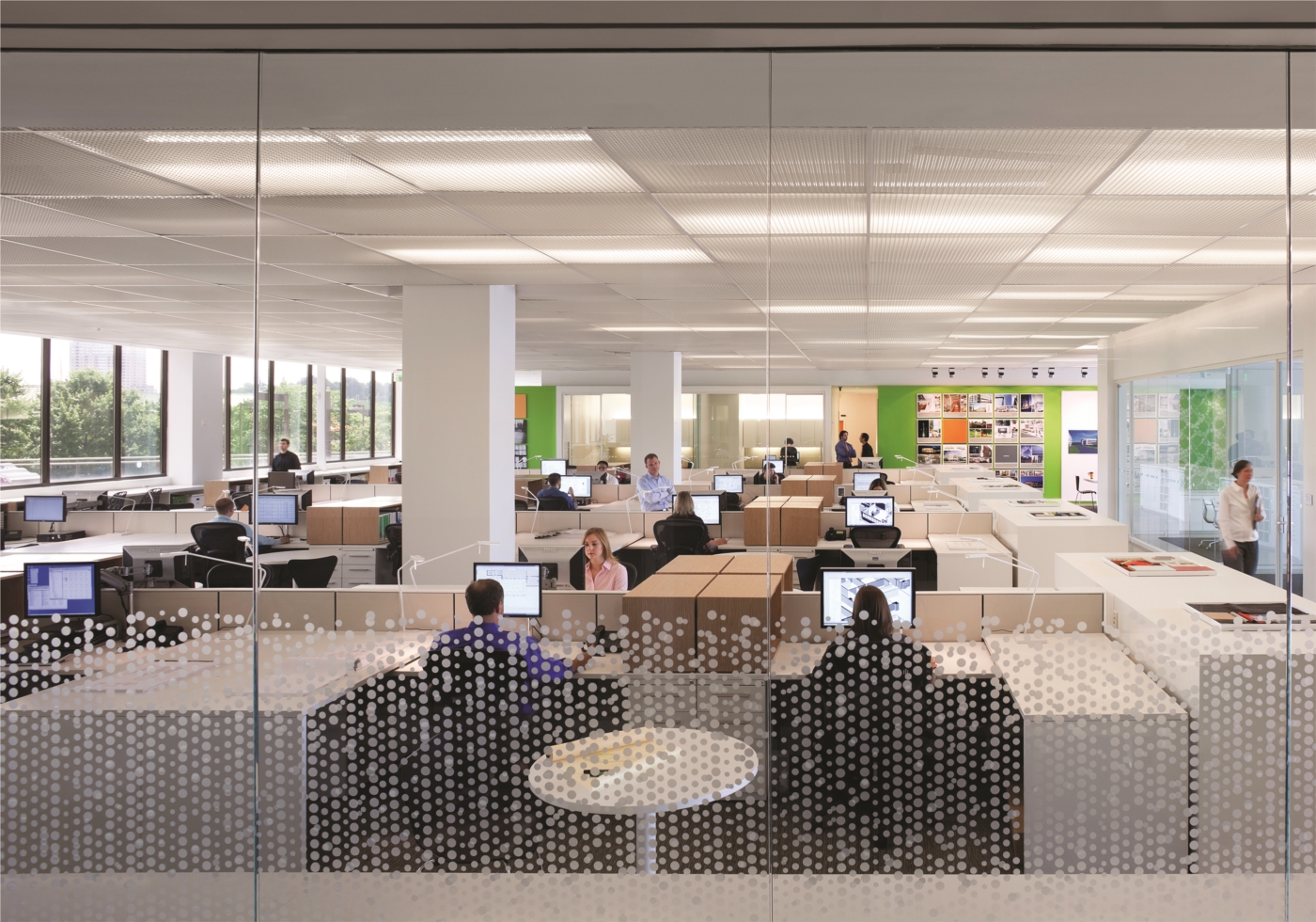 Looking through the glass wall in the reception area, you can see Gensler Baltimore's open concept work space.