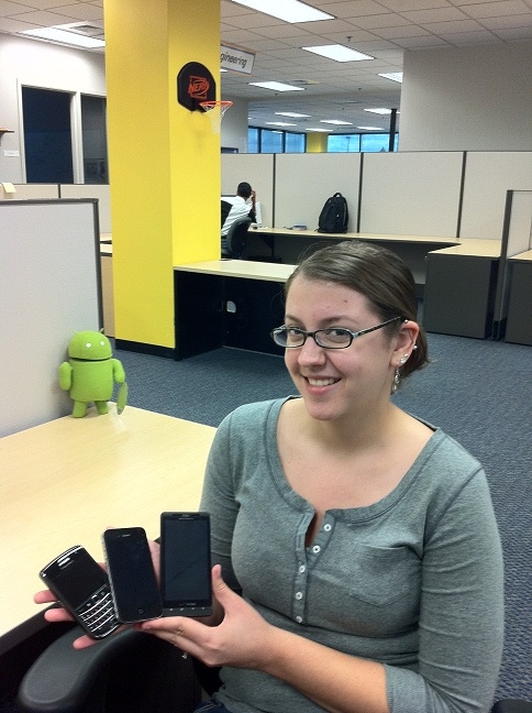 Liz Turman poses with the mobile trifecta: Android, Apple, and BlackBerry.