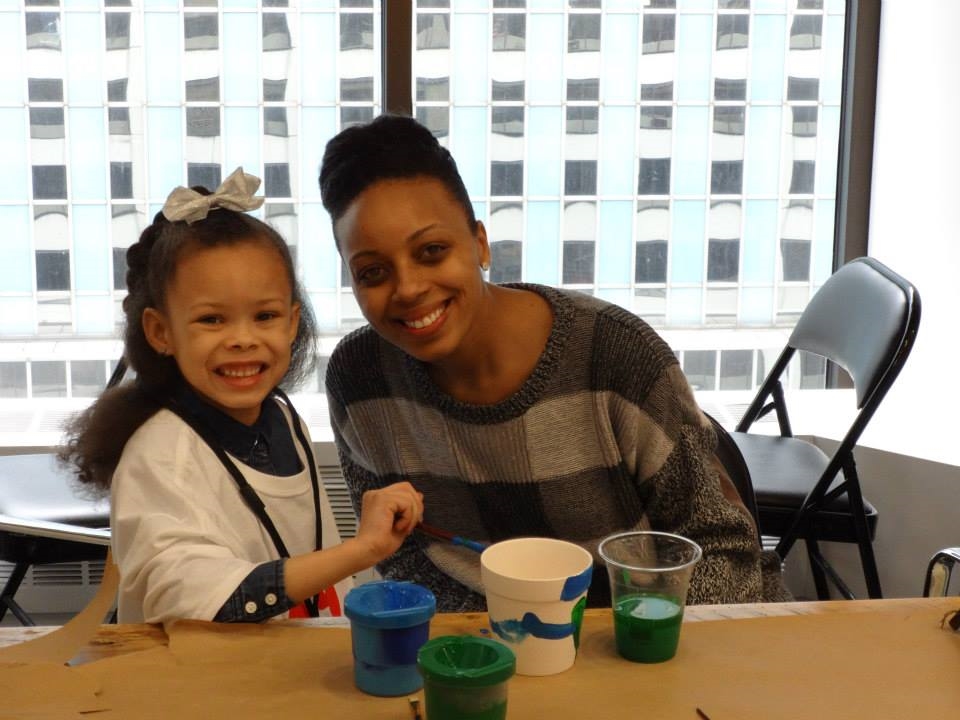 Tatiana Arrington and her daughter paint flower pots during our annual "Take our Kids to Work Day".