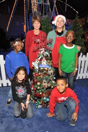 Baird associates pose with students who participated in the Children Celebrate Children event. The decorated trees were displayed at Children’s Memorial Hospital for patients and their families to enjoy. 