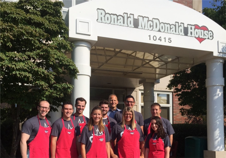 A group of Cohen & Company volunteers ready to prepare brunch at the Ronald McDonald House during the firm's community service day.