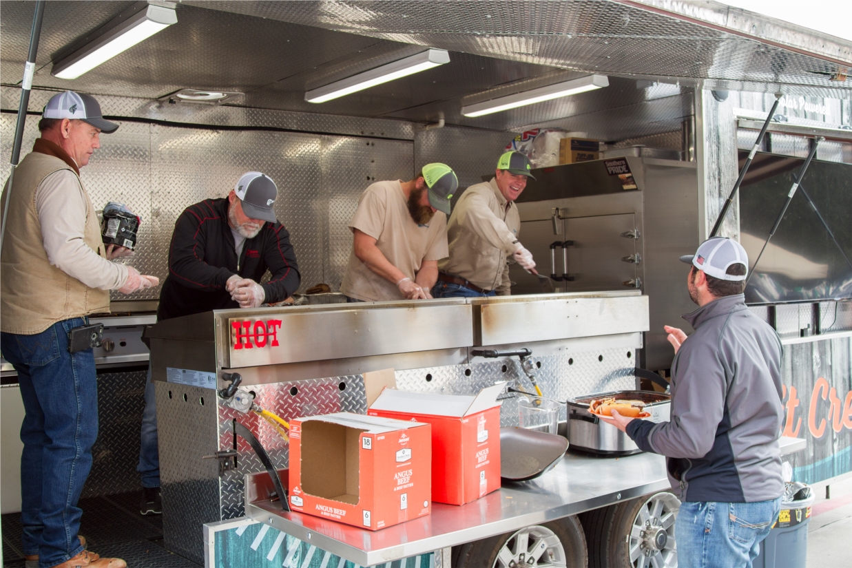 Employees staff the CoServ Pit Crew food trailer, which feeds colleagues, members and customers alike.