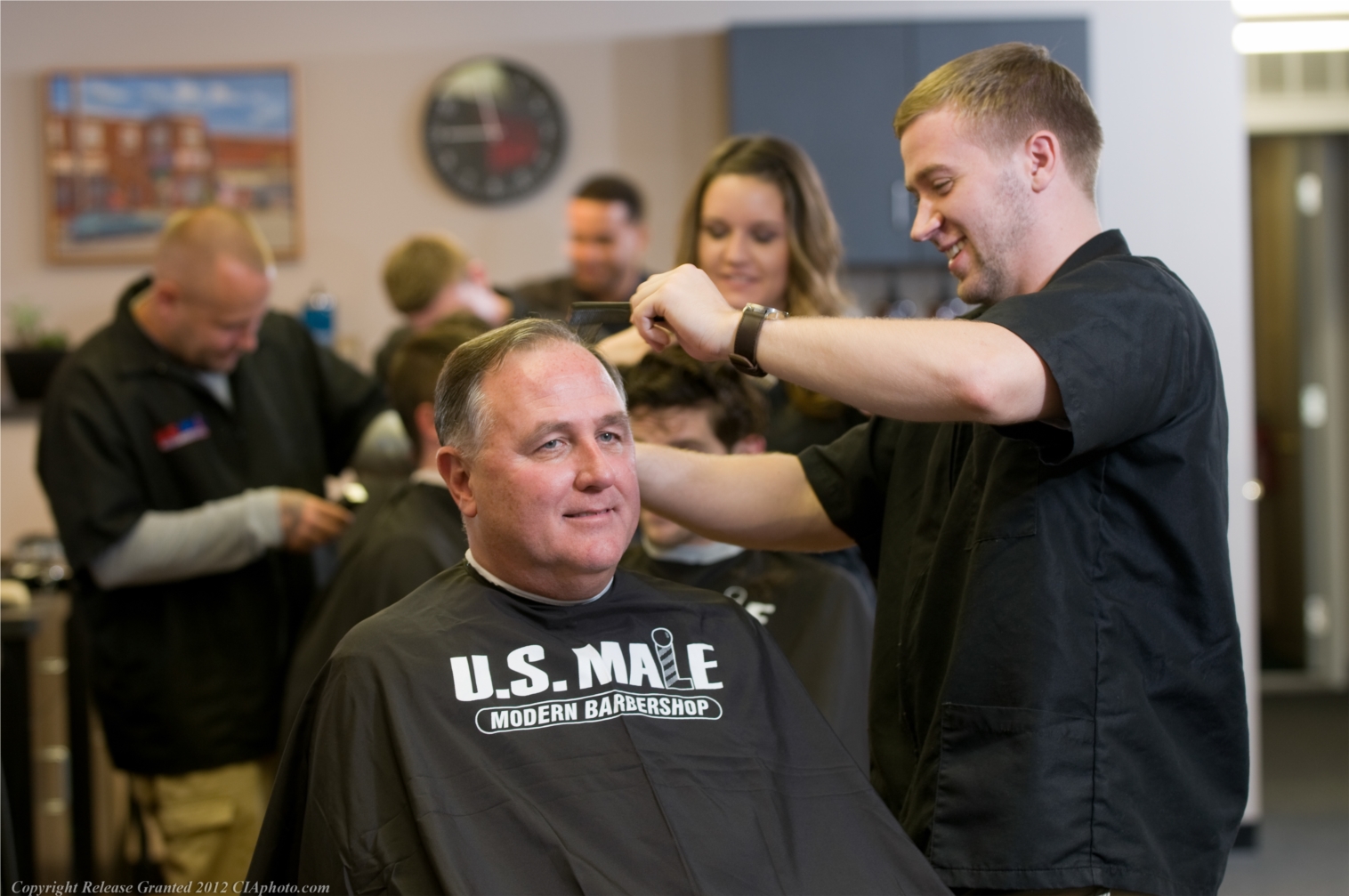 Marc cutting a happy client's hair