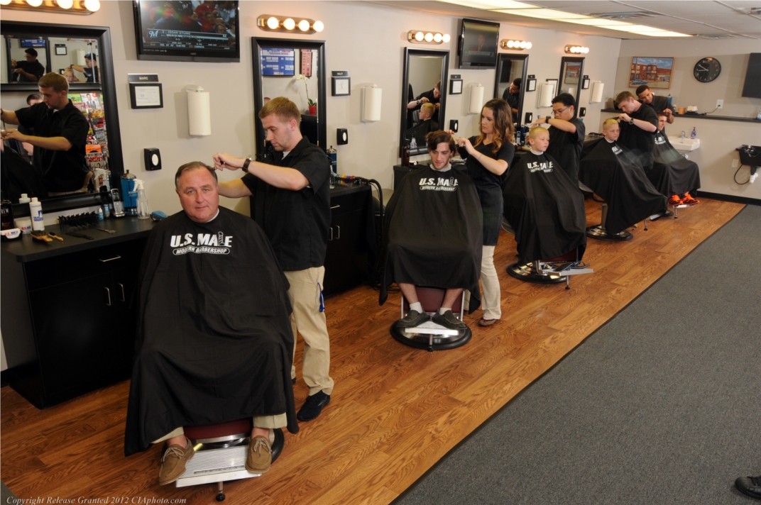 Marc, Haley, Jim, Tim, and Mike performing haircuts on their clients