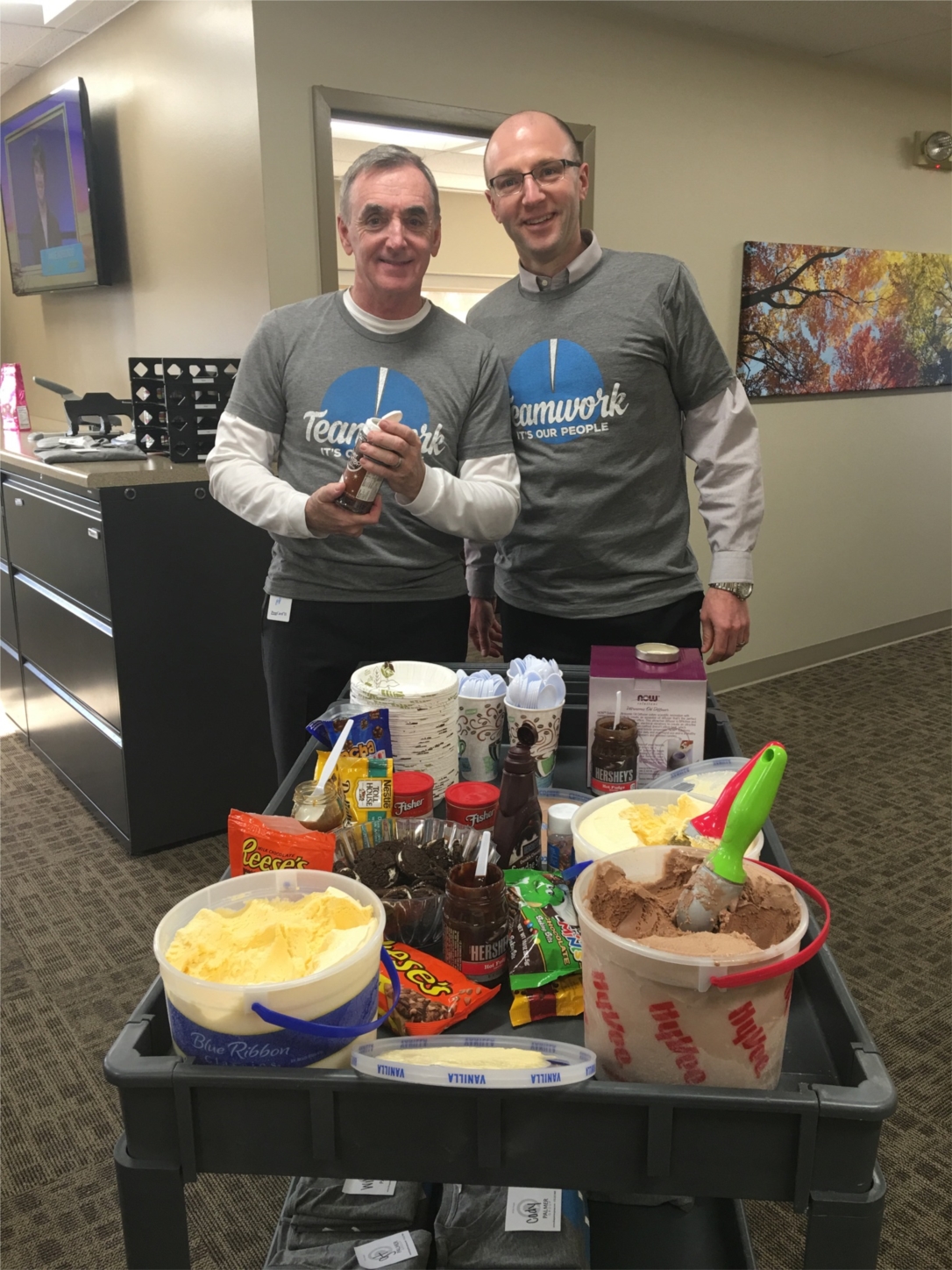Austin Palmer  / David Leto serving their employees ice cream sundaes and teamwork t-shirts.
