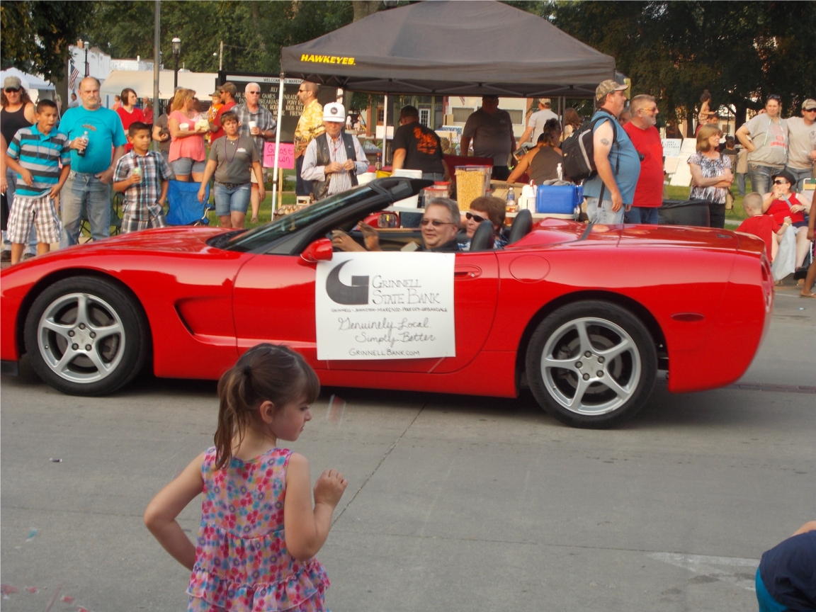 Branch Manager representing Grinnell State Bank in the annual 4th of July Parade in Marengo!