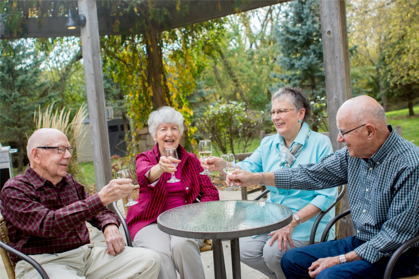 Northcrest residents enjoying a glass of wine outside at the Pergola