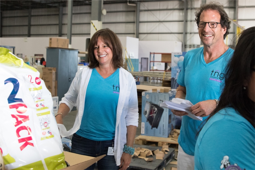 Larry & Teresa handing out our Summer Survival Kits. Gifts they purchased for each employee.