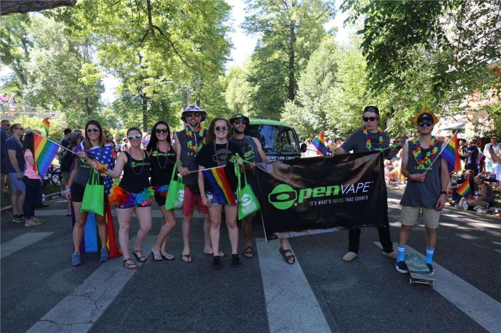 The Organa Brands team marching with the O.penVAPE bus at Denver Pride 