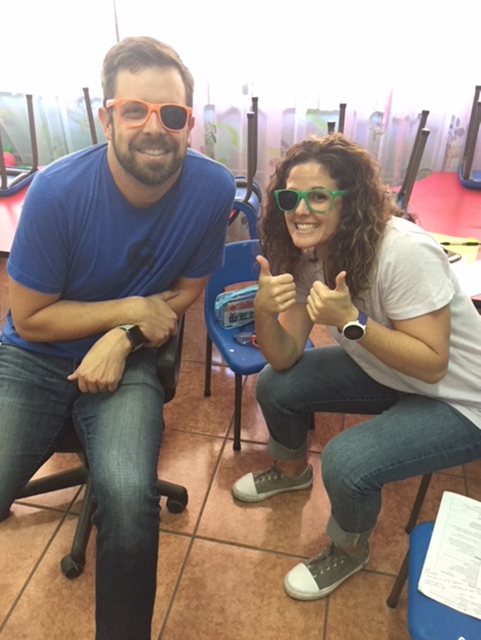 Employees giving kids in Costa Rica eye exams as part of a volunteer trip. 