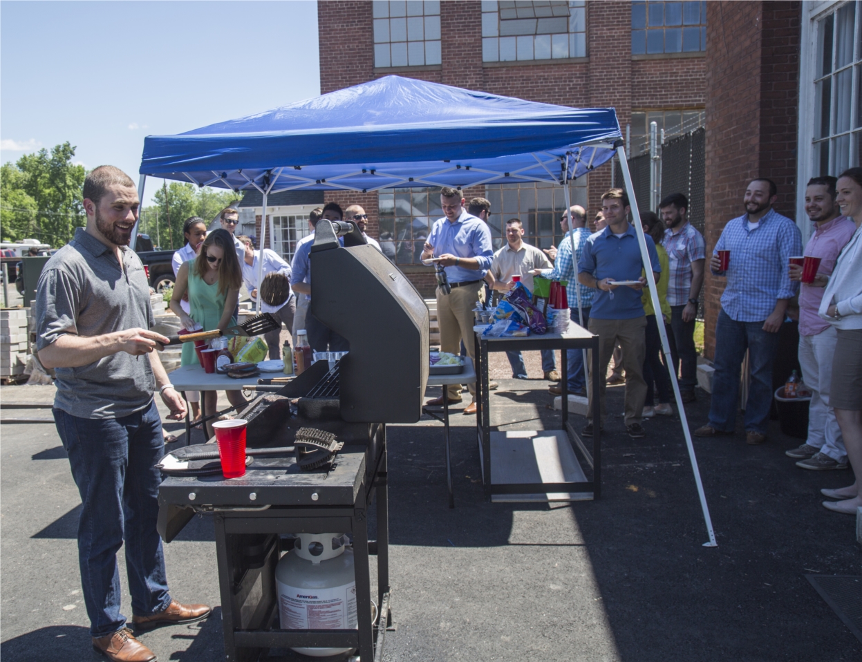Greenskies team members cooking and enjoying a Monday barbecue lunch