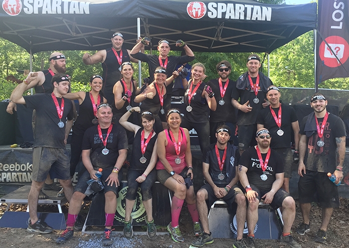 A large group of employees trained together for several months and participated in a Spartan Race.