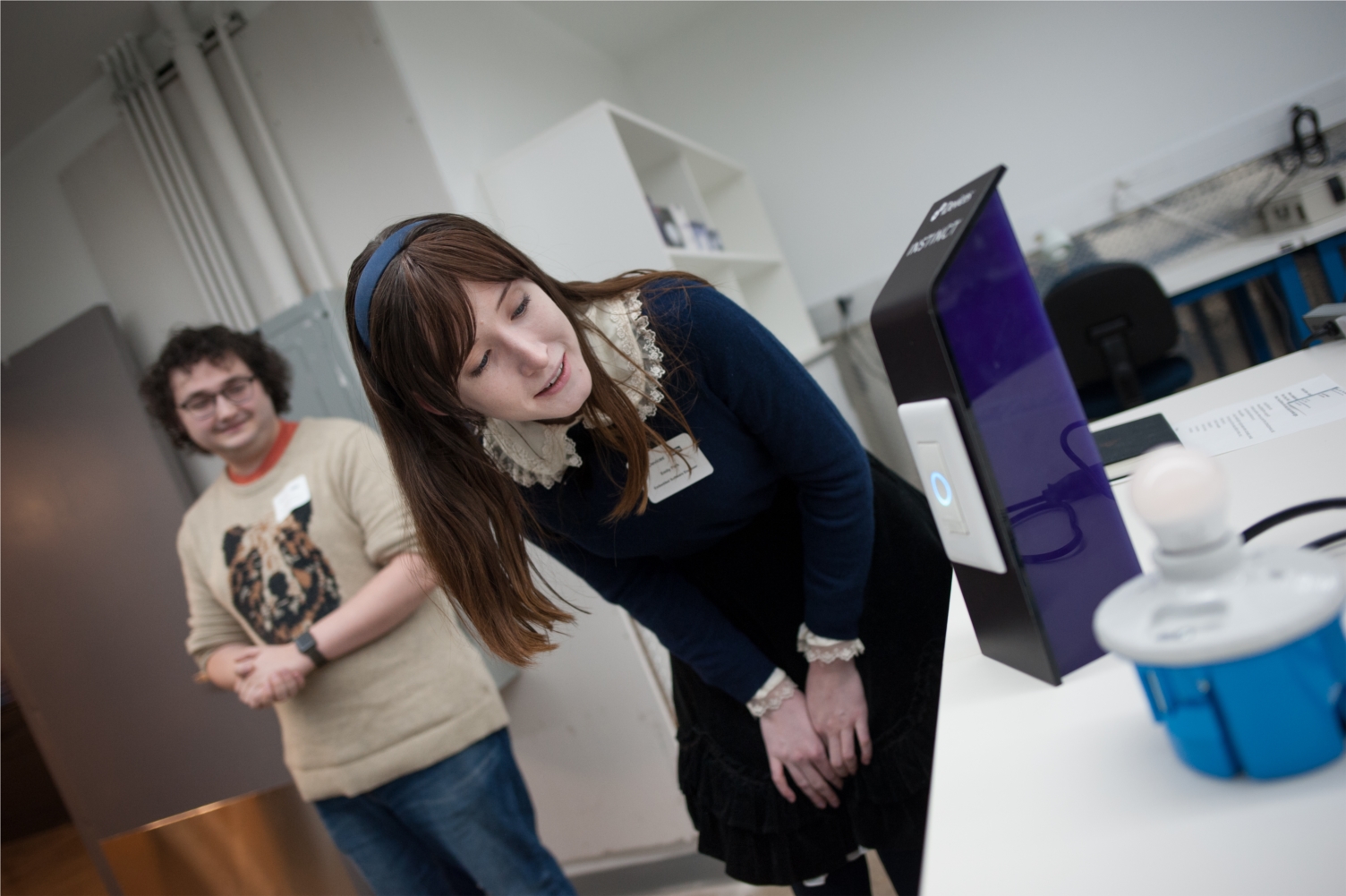 Embedded Software Engineer Emily Park shows off the capabilities of Instinct™, a smart light switch with Alexa built-in, to members of the public during the grand opening event for iDevices' new headquarters in Avon on April 2, 2019. 