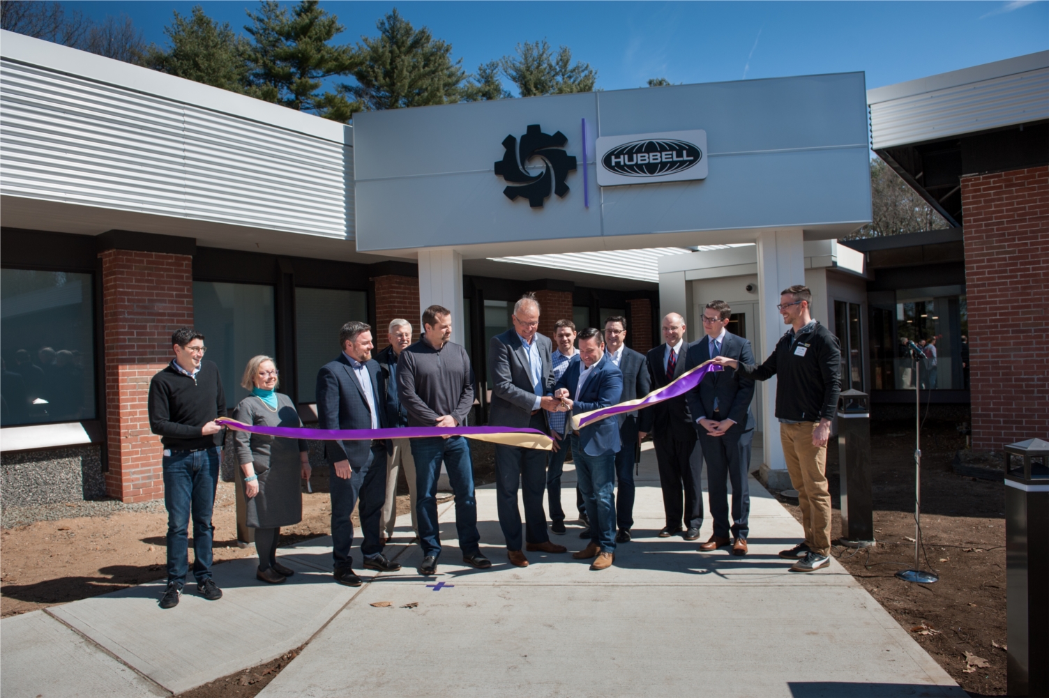 iDevices President Chris Allen (at right, cutting ribbon) and Hubbell Incorporated Chairman and CEO David Nord (at left, cutting ribbon) cut the ceremonial ribbon during the grand opening event for iDevices' new headquarters in Avon on April 2, 2019. iDevices was acquired by Shelton-based Hubbell Incorporated in 2017. 