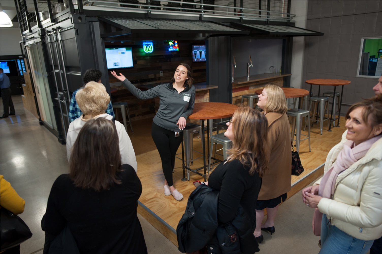 UX Designer Chelsea Clapper (at center) takes visitors on a tour of iDevices' new headquarters in Avon during a grand opening event on April 2, 2019. 