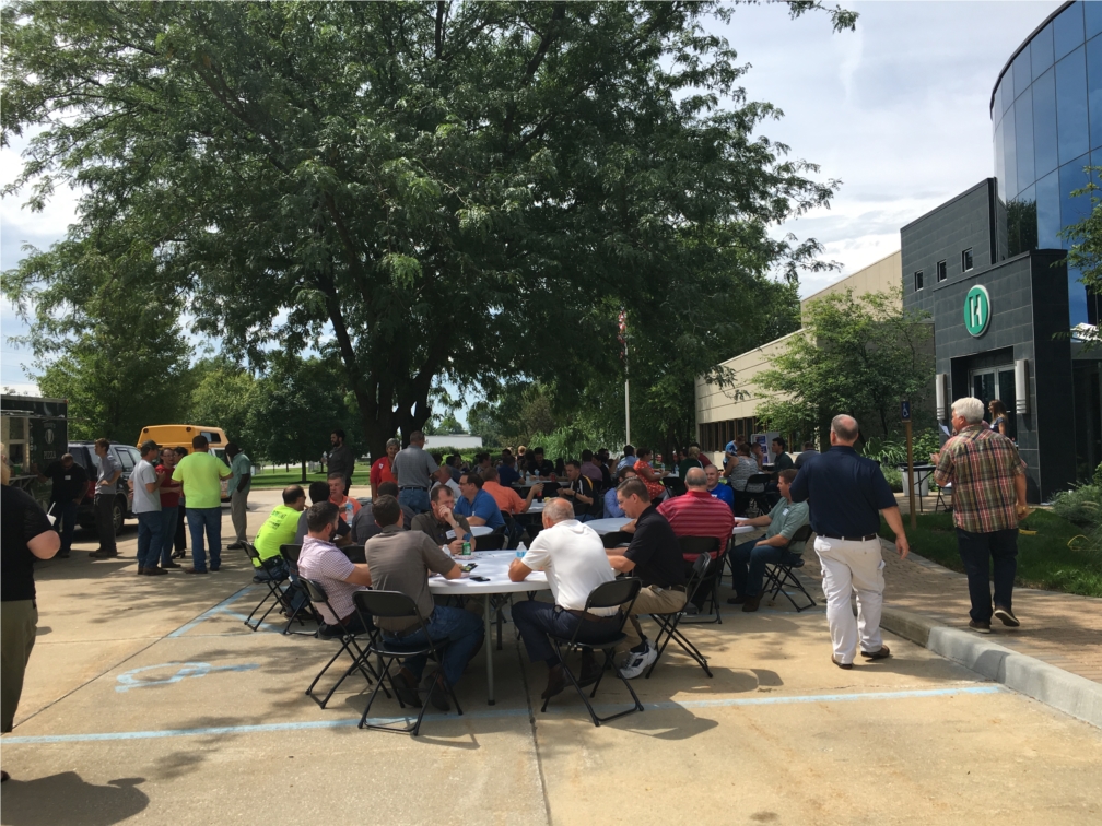 Employees enjoying lunch outside for Food Truck Friday, a new summer tradition.