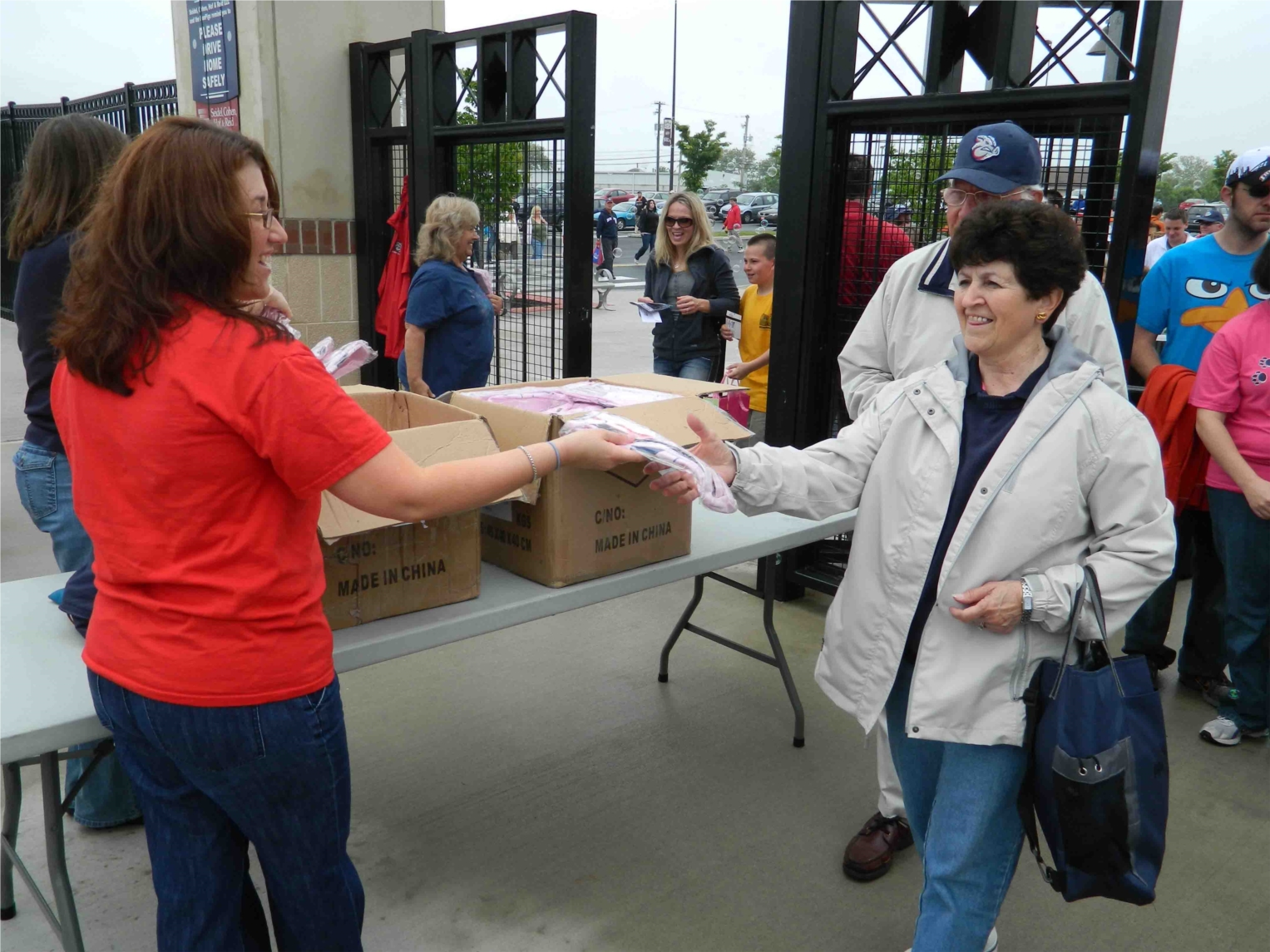 American Bank's team members are committed to the Lehigh Valley because this is where we live and work.  In this photo, team member Mary Hodrick volunteers at an IronPigs game when American Bank sponsored the pink jersey purse giveaway.