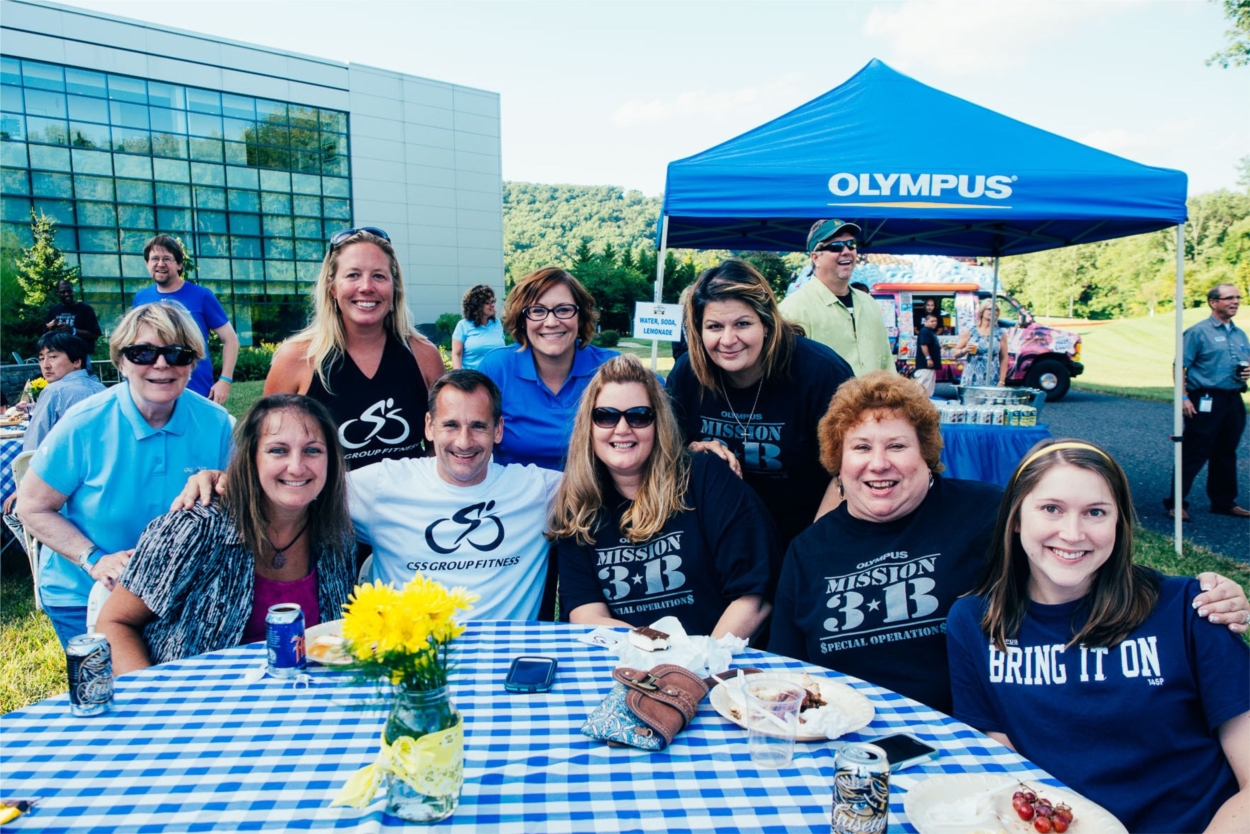 Olympus employees enjoy a summer evening, a barbecue, and good tunes at the "Back-yard BBQ and the Band" event.