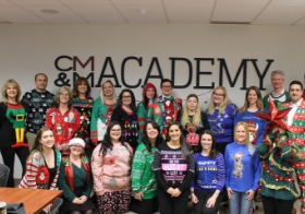 CMM staff members pose during our ugly sweater party to celebrate the holidays.