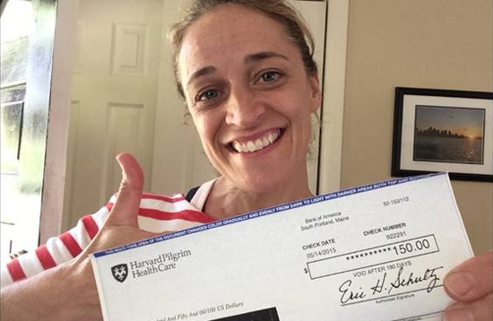 Dawn Damiano, HSL's LiveWELL leader, showing her fitness reimbursement check from Harvard Pilgrim Health Care