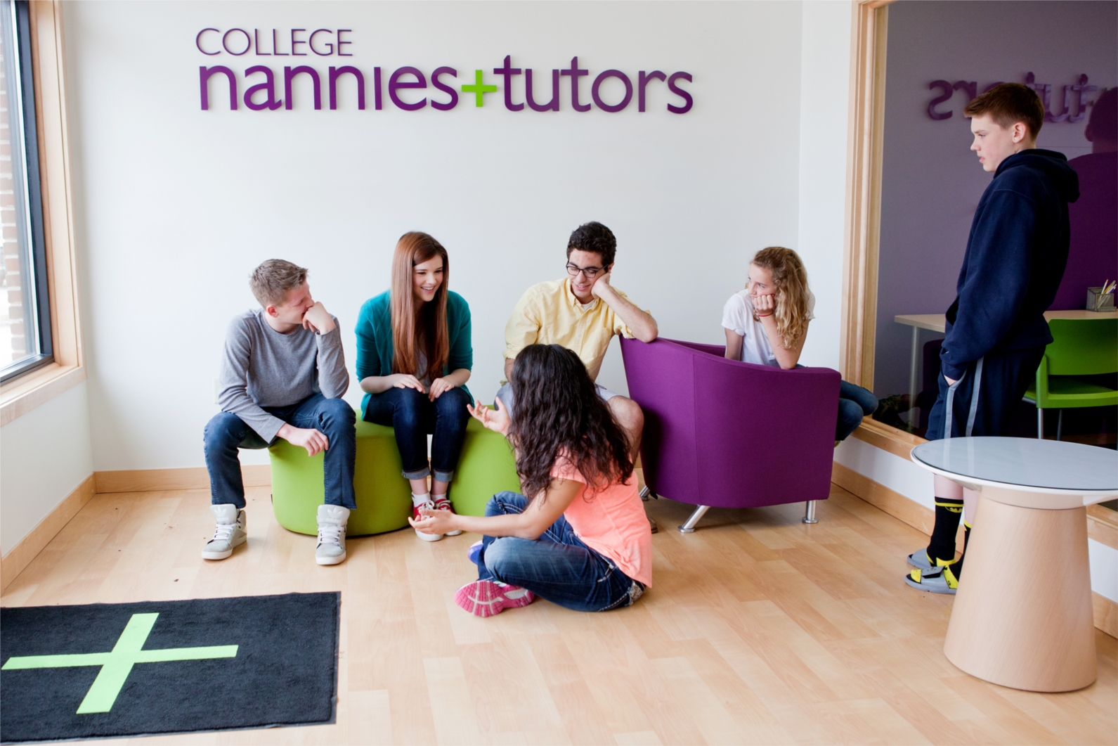 Students enjoying College Nannies + Tutors’ lobby hang-out area