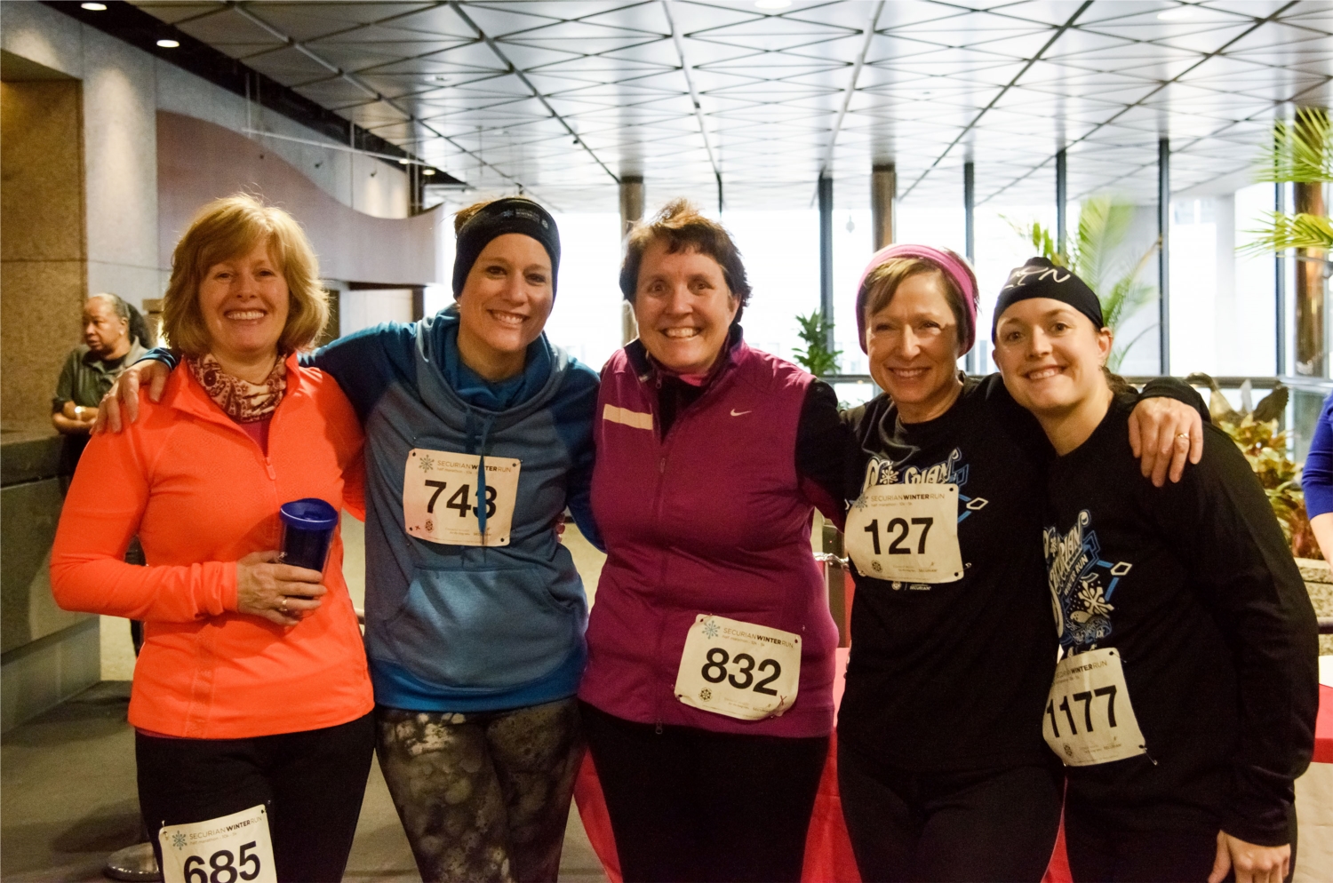 Associates pose for a picture after completing the 5k or 10k Securian Winter Run, which Securian sponsors each year in support of the Saint Paul Winter Carnival.