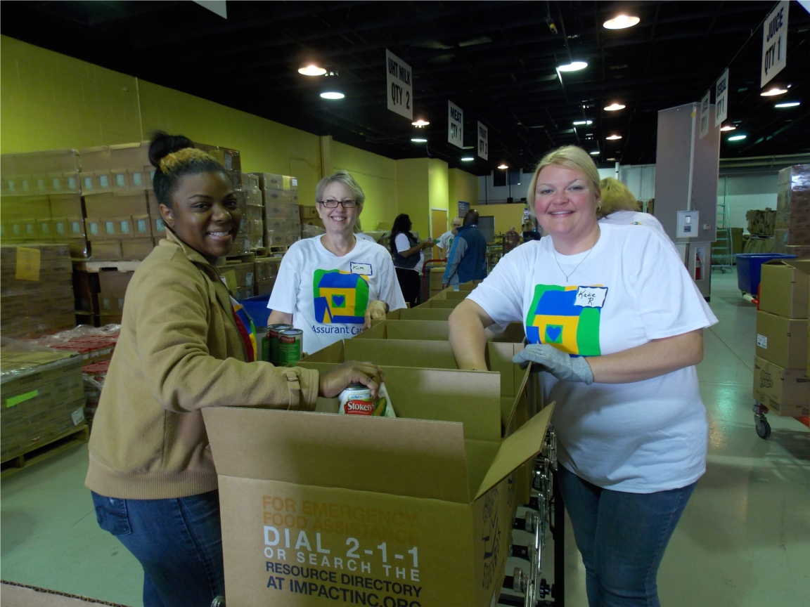 Assurant Health employees volunteer their time at Hunger Task Force during the company’s week-long Assurant Health Cares Week event. From left: Chris Gilmore, Daaiyah Reid