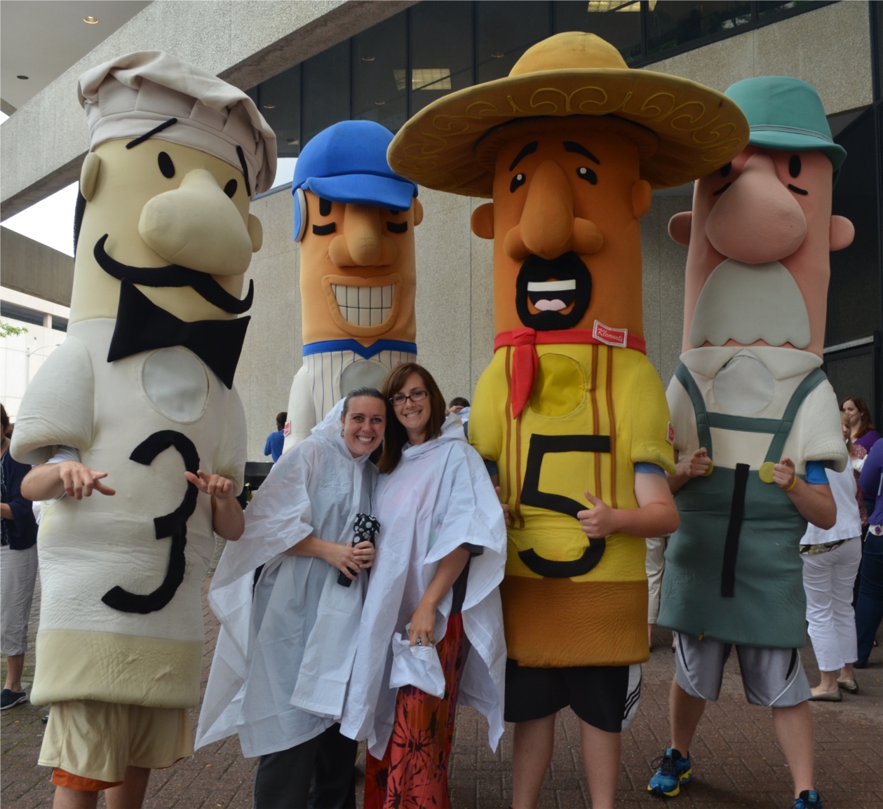 Assurant Health employees enjoy a (rainy) summer block party with the Milwaukee Brewers Racing Sausages – this is one of several surprise events planned throughout the year to thank employees for their contributions. From left: Rachel Frosch, Heidi Fischer