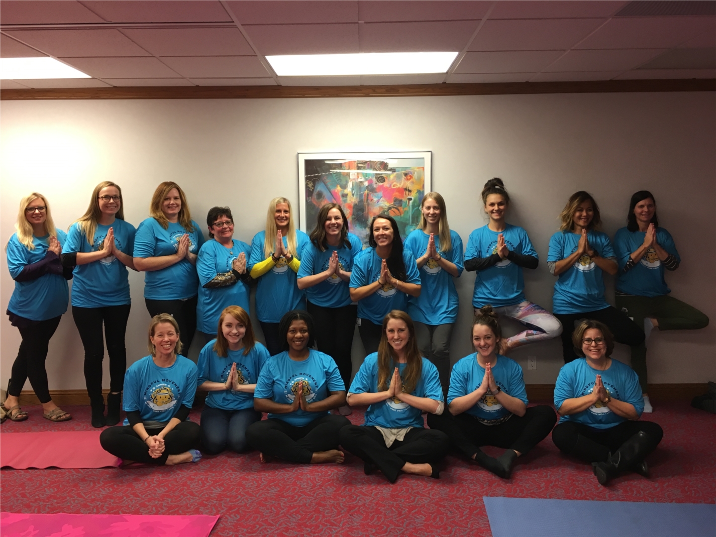 Posing for a photo after an on-site yoga session to celebrate "Mindful Movement."