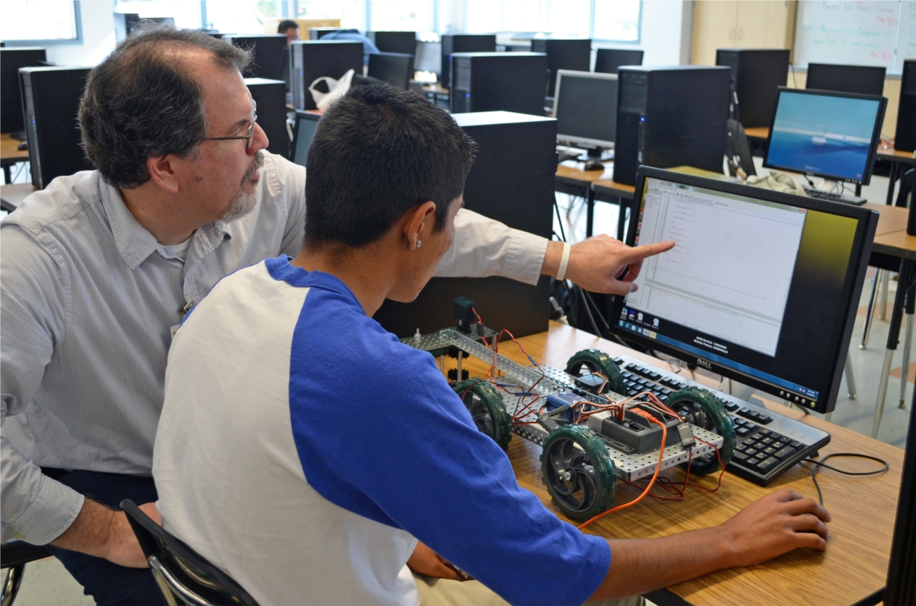 ROP Instructor Dan Zanone, Engineering, works with a student to create a vector robot.