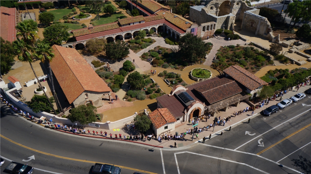 Mission staff and public supporters join hands to "hug" the Mission during "Hands Around the Mission" event celebrating the birthplace of Orange County and OC's 125th year celebration.