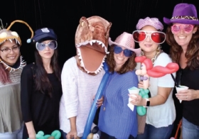 Members of our sales and research consultant teams get together for a silly photo booth pic during movie night.