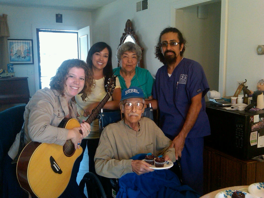 Here our Certified Home Health Aide, Fernando Perez, and Music Therapist, Andrea Scheve, provide a birthday celebration for a hospice patient.  Patient birthdays are usually celebrated by our hospice team with a party, cake, and music. 