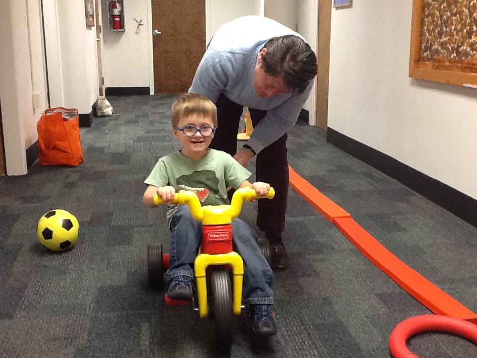 An InterMountain ESD physical therapist works with a child.