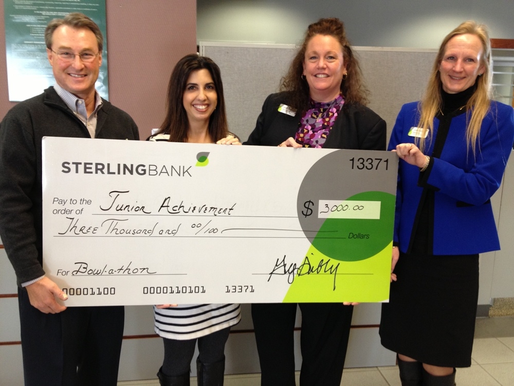 Sterling Bank employees in Oregon present a check to Junior Achievement