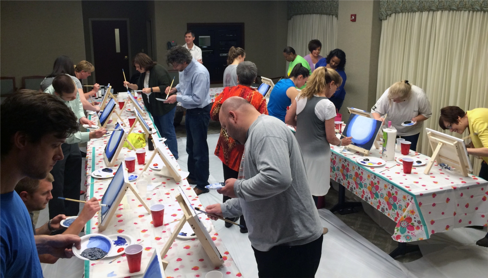 Professional artist and W. M. Jordan staff member Alyssa Delly leads the team in a Fun at Four painting class.