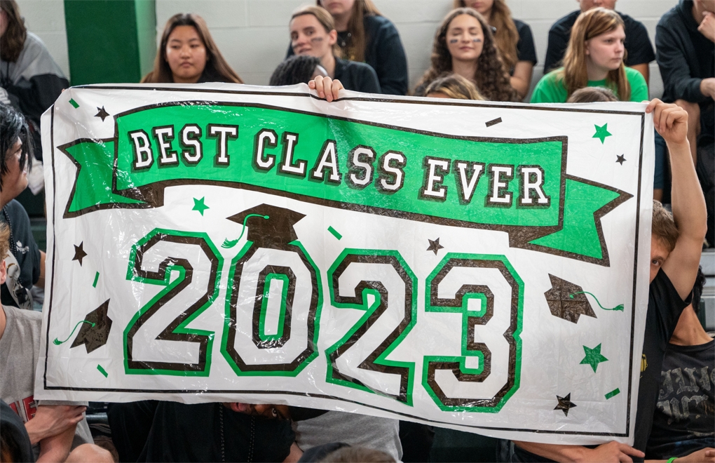 A group of seniors holding a banner