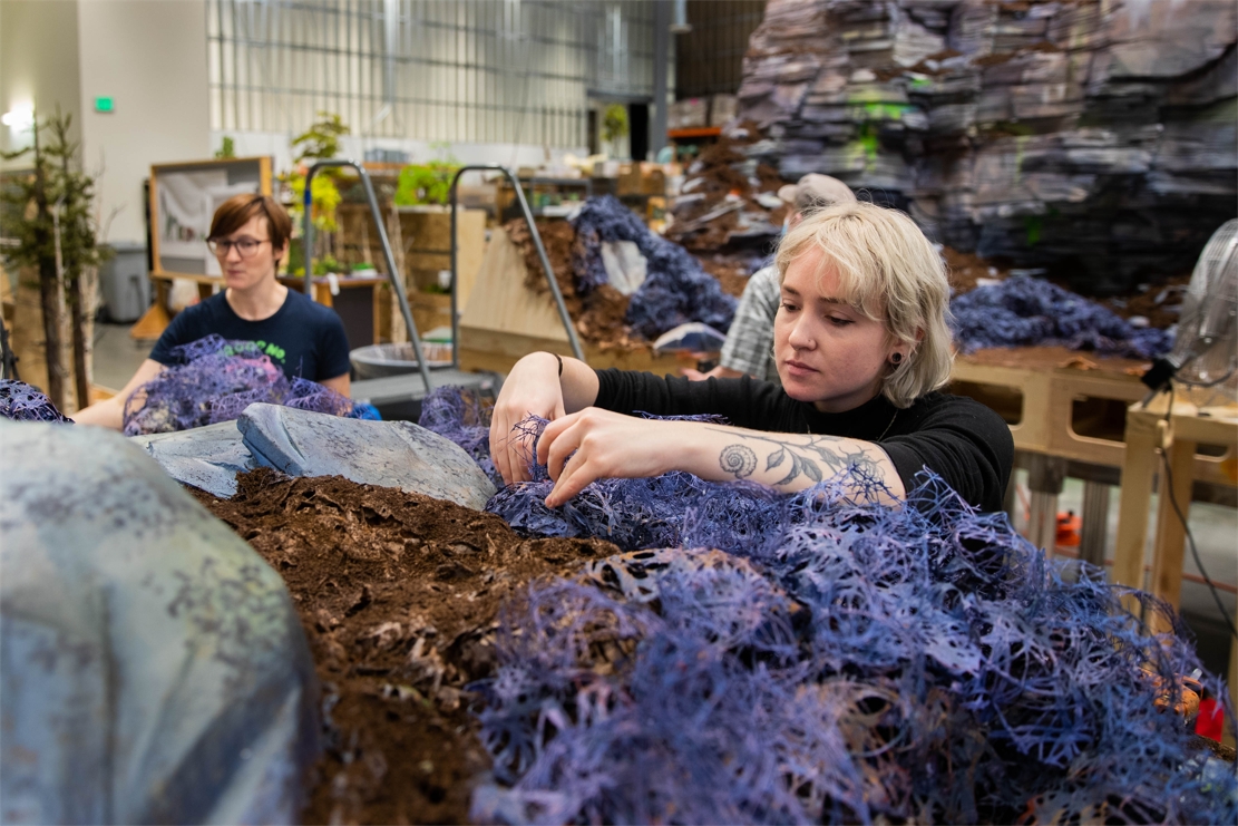 Landscape Artists Jessica Holtman (left) and Abigail Austin install bushes onto a set before it moves to the stages. LAIKA is currently in production on its sixth animated feature, WILDWOOD.