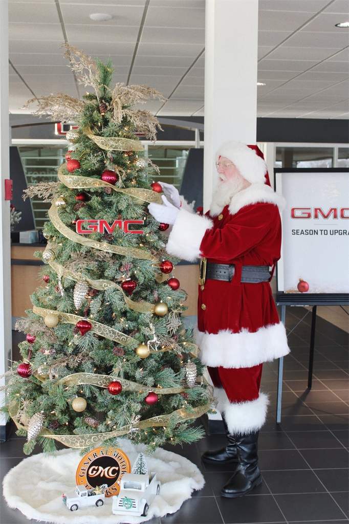 Santa and our GMC Christmas Tree.jpg