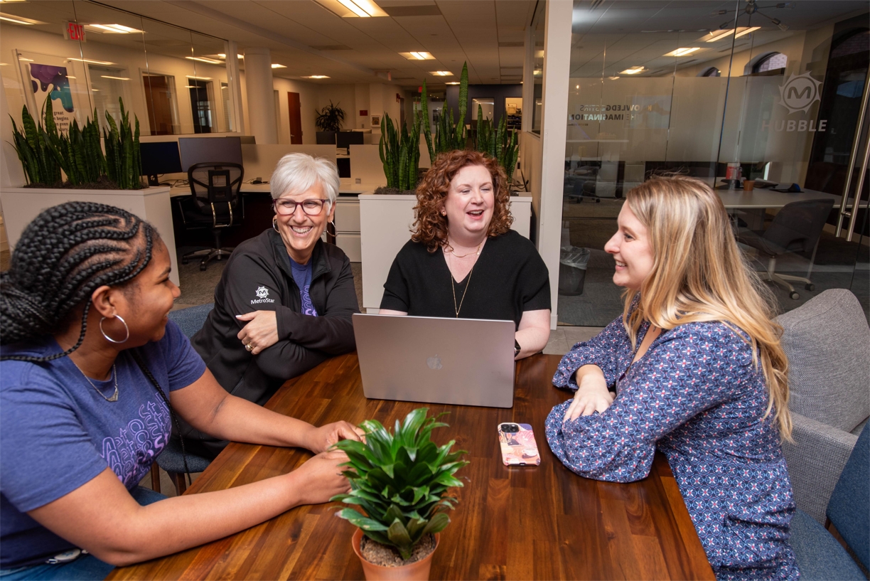 MetroStar employees collaborating in the office.