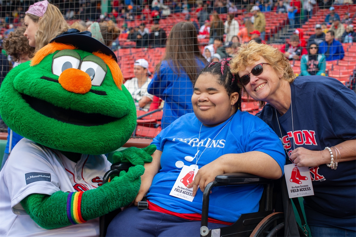 Student and teacher pose with the Red Sox mascot, Wally