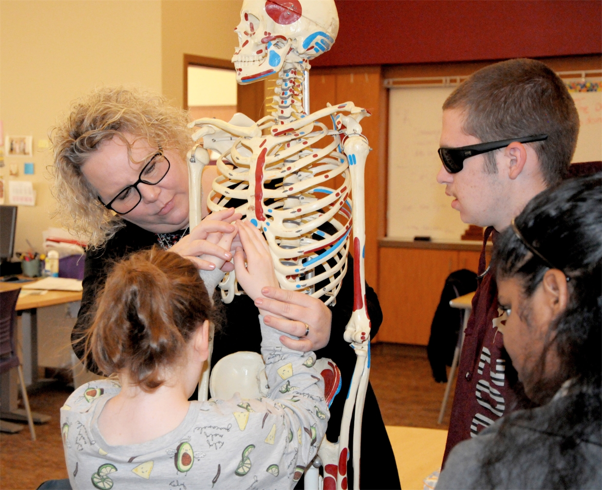 NMSBVI_ Transition Coordinator (former EMT) Holly Bird guides Kambree's hands on a skeleton to find the correct spot to perform CPR.jpg
