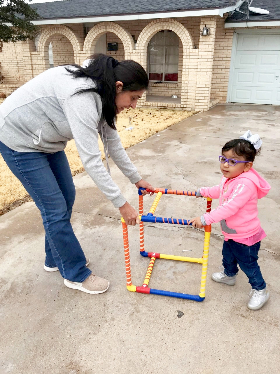 With a little help from Birth-to-3 Orientation & Mobility Specialist Ms. Sophia Diaz, Nayelli works on taking steps using her new Adapted Mobility Device.jpg