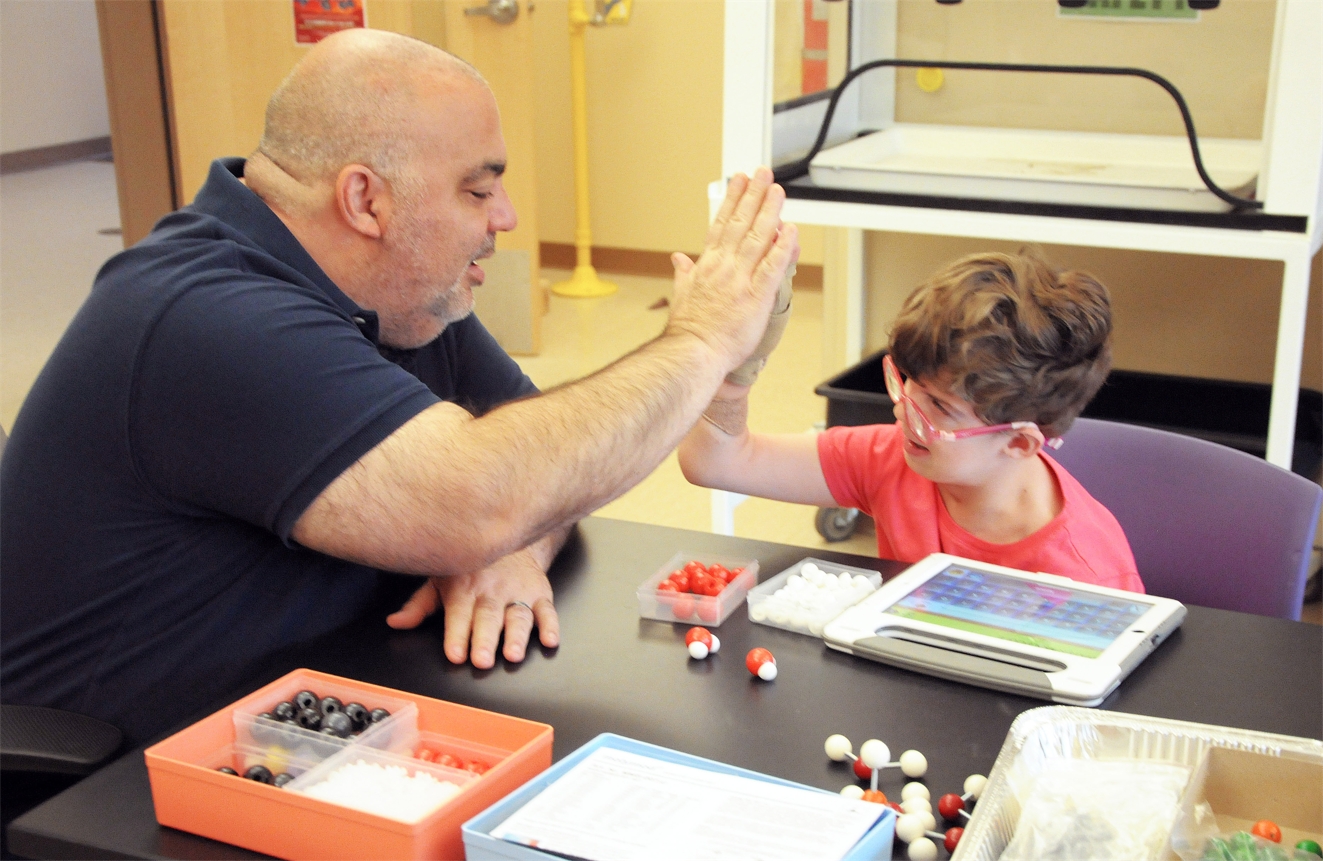 NMSBVI_ Science Instructor Jeff Killebrew gives student Mandy a high-five after she answers a question correctly in the classroom.jpg
